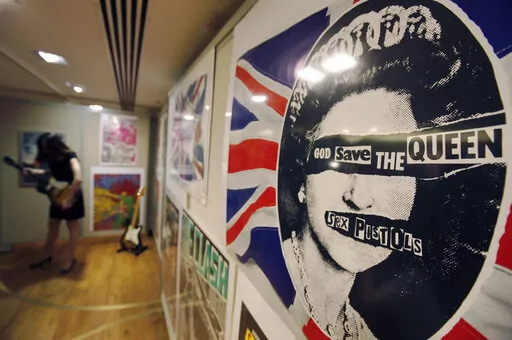 A  promotional poster for the 1977 single God Save The Queen by the Sex Pistols on display, during a photo-op ahead of a rock and pop memorabilia auction, in central London, Thursday June 25, 2009. In Britain, there are several traditional elements to a royal anniversary: pageants, street parties, the Sex Pistols. Queen Elizabeth II and the Pistols have been linked since the punk pioneers released the song “God Save the Queen” in 1977 during the monarch’s Silver Jubilee.   (AP Photo/Lefter
