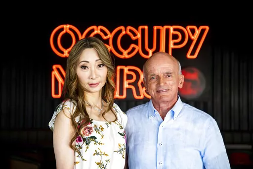 This photo provided by SpaceX photo shows Dennis Tito and his wife, Akiko, at the company’s Starship rocket base near Boca Chica, Texas, on Monday, Oct. 10, 2022. The couple has booked a flight to the moon on SpaceX’s Starship. (SpaceX via AP)