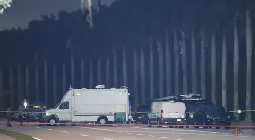 Police crime scene vehicles are seen at Trump International Golf Club after police closed off the area following the apparent assassination attempt of Republican presidential nominee former President Donald Trump in West Palm Beach, Fla., Sunday, Sept. 15, 2024. (AP Photo/Terry Renna)