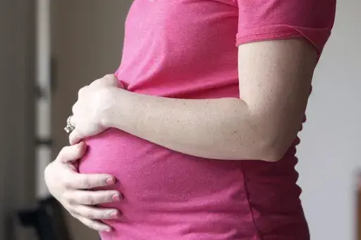 A pregnant woman stands for a portrait in Dallas, Thursday, May 18, 2023. (AP Photo/LM Otero, File)