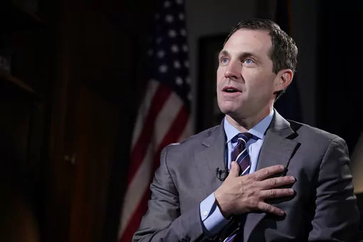 Rep. Jason Crow, D-Colo., talks during an interview with The Associated Press in his office on Capitol Hill in Washington, Dec. 15, 2021. Two decades ago, Crow was a 24-year-old platoon leader in the American invasion of Iraq. Platoon members carried gas masks and gear to wear over their uniforms to protect them from the chemical weapons the U.S. believed – wrongly – that Iraqi forces might use against them. Today, Crow sits on committees that oversee the U.S. military and intelligence agenc