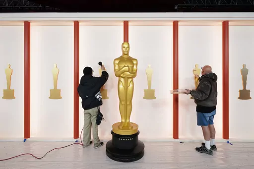Workers prepare a backdrop during preparations for Sunday's 95th Academy Awards, Friday, March 10, 2023, in Los Angeles. (AP Photo/Ashley Landis)