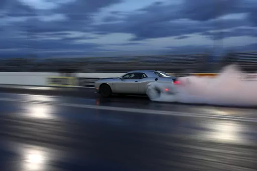 The 2023 Challenger SRT Demon 170 races down a drag strip during an event to unveil the car Monday, March 20, 2023, in Las Vegas. (AP Photo/John Locher)