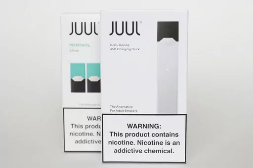 Packaging for an electronic cigarette and menthol pods from Juul Labs is displayed on Feb. 25, 2020, in Pembroke Pines, Fla. In a deal announced Tuesday, Sept. 6, 2022, electronic cigarette maker Juul Labs will pay nearly $440 million to settle a two-year investigation by 33 states into the marketing of its high-nicotine vaping products, which have long been blamed for sparking a national surge in teen vaping. (AP Photo/Brynn Anderson, File)