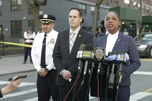 In this image taken from video provided by the NYPD, New York Police Commissioner Keechant Sewel, right, speaks during a news conference, Friday, April 8, 2022, in New York. A teenage girl has been killed and two other teens wounded in a shooting near a Bronx school. (NYPD via AP)